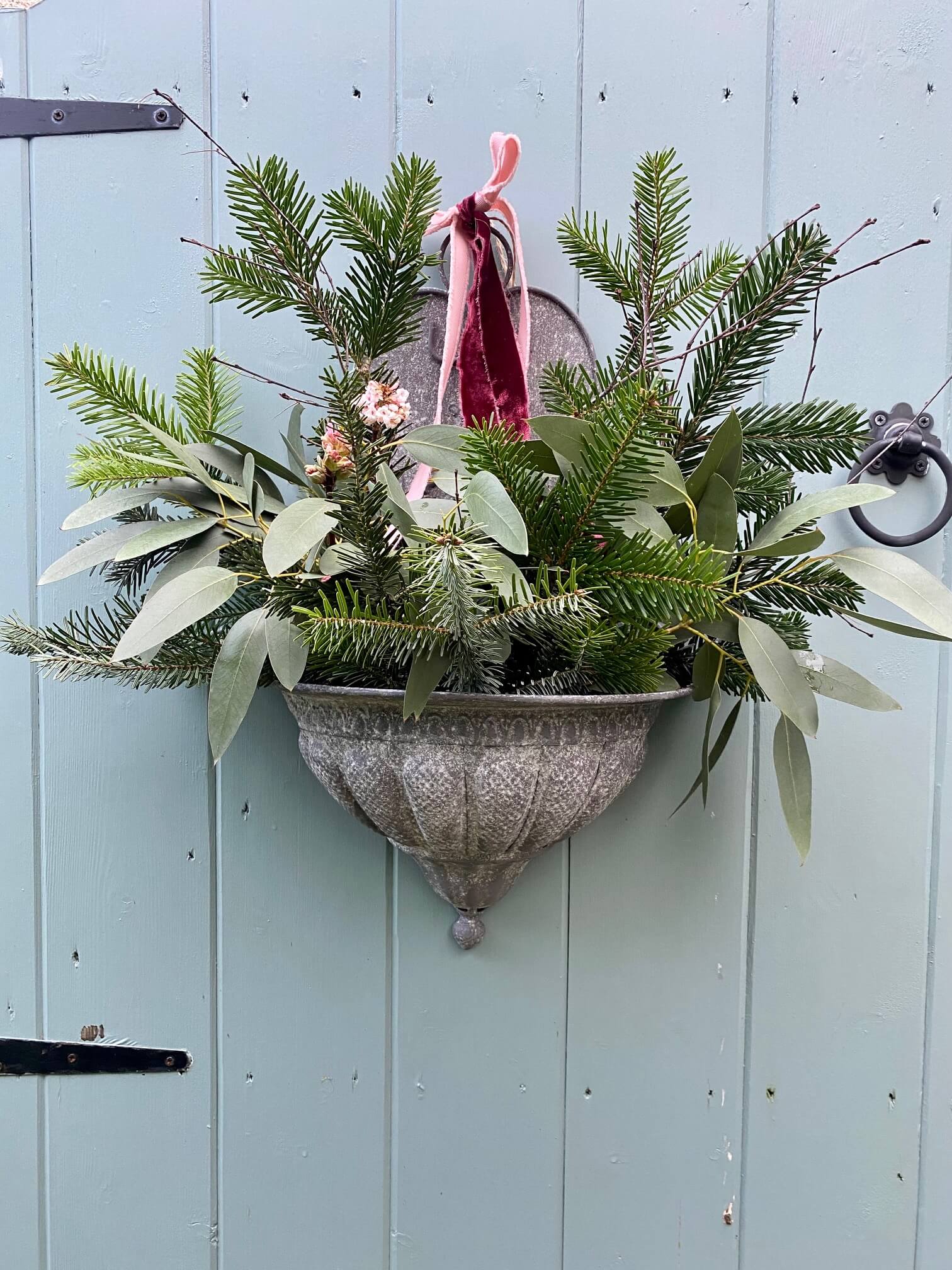 How to Create Festive Door Decor Using a Wall Planter - Amber + Willow