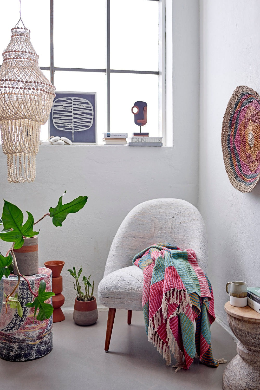 recycled cotton colourful through draped on white armchair in a bohemian styled room