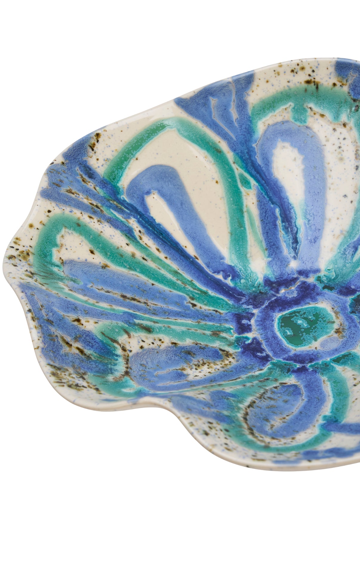 Ceramic bowl with ruffled edge with blue and green marbled pattern on a white background