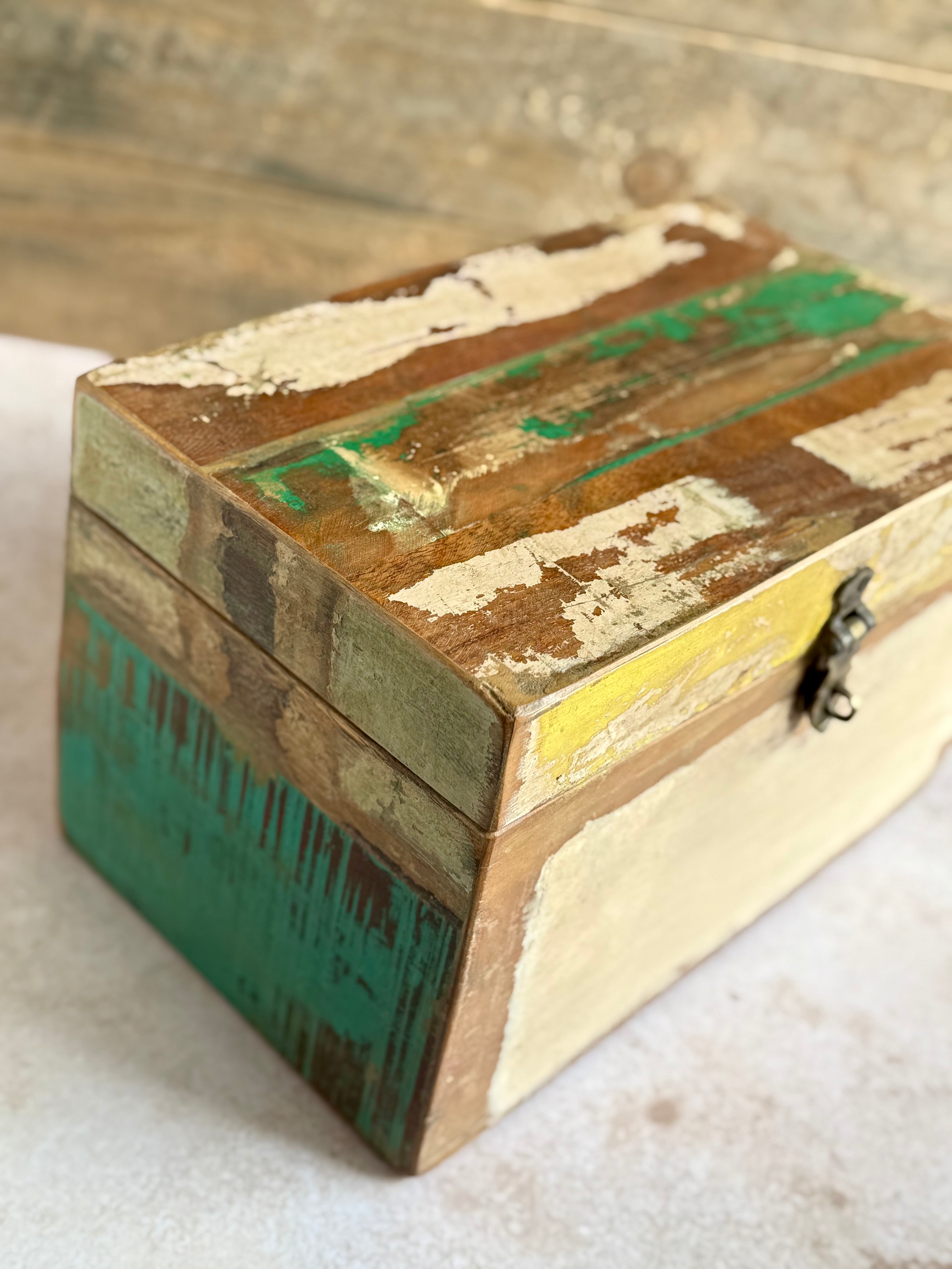 Wooden box with distressed finish on a light background