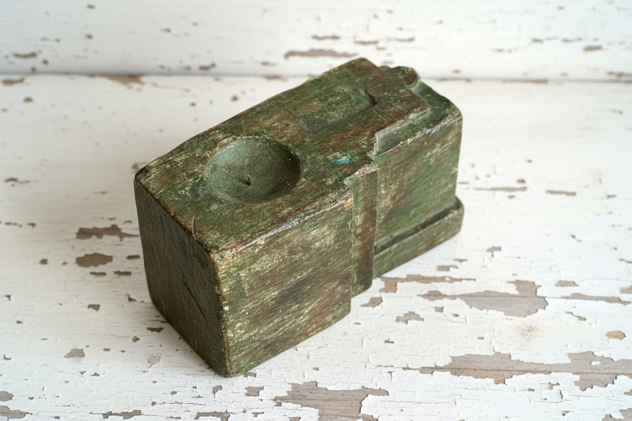 Repurposed salvaged wood with rustic green patina on a wooden surface.