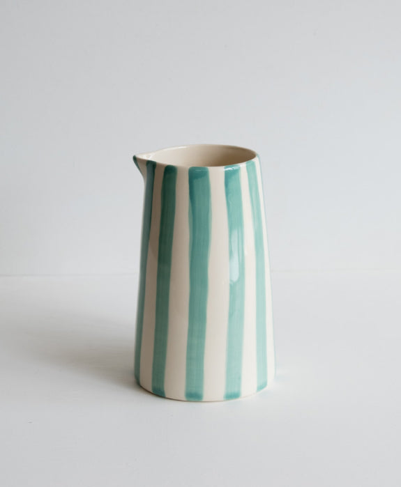 A ceramic pitcher with candy stripes in mint on white background