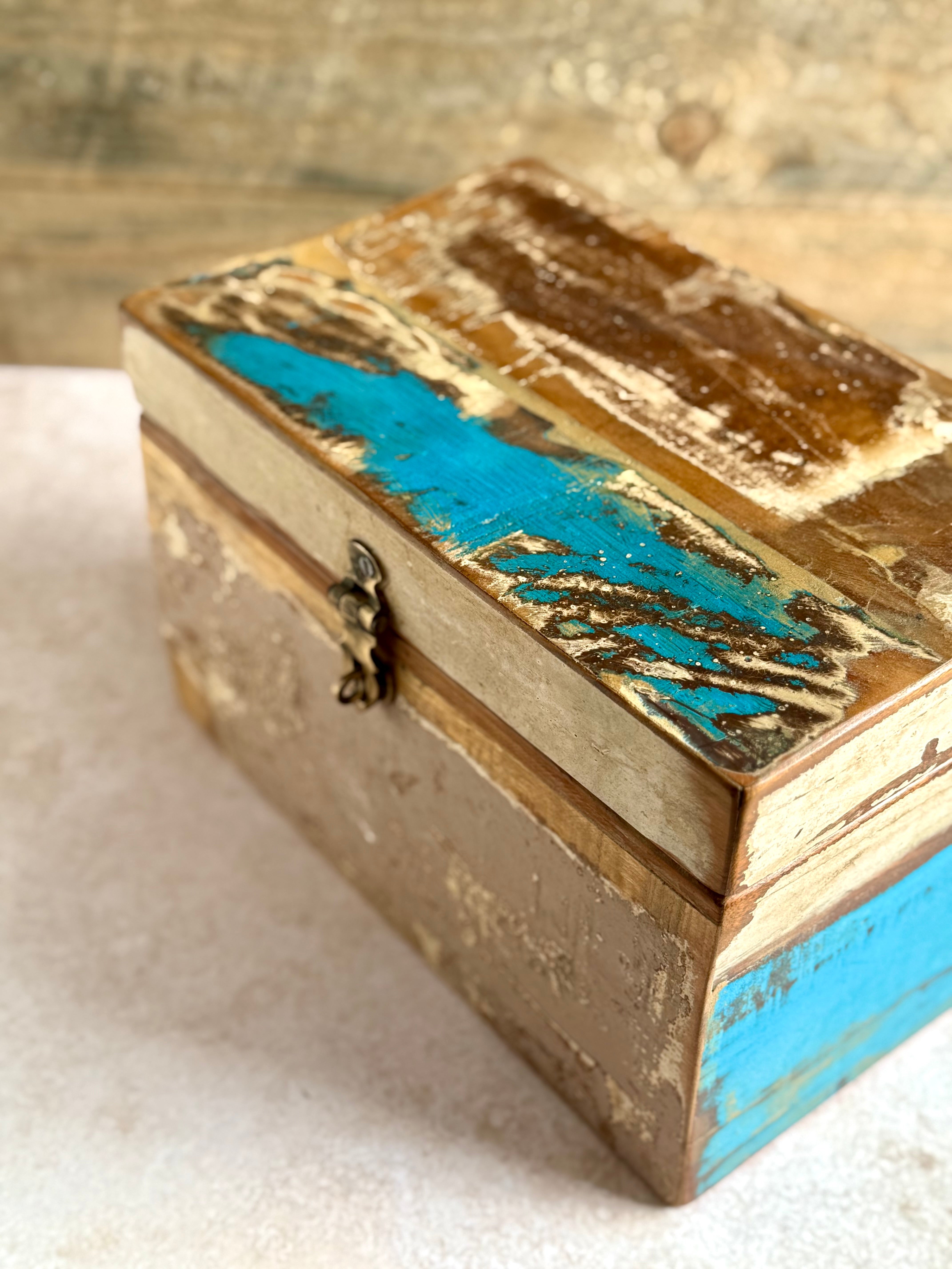 Detail shot of reclaimed scrapwood box with turquoise, brown and cream tones