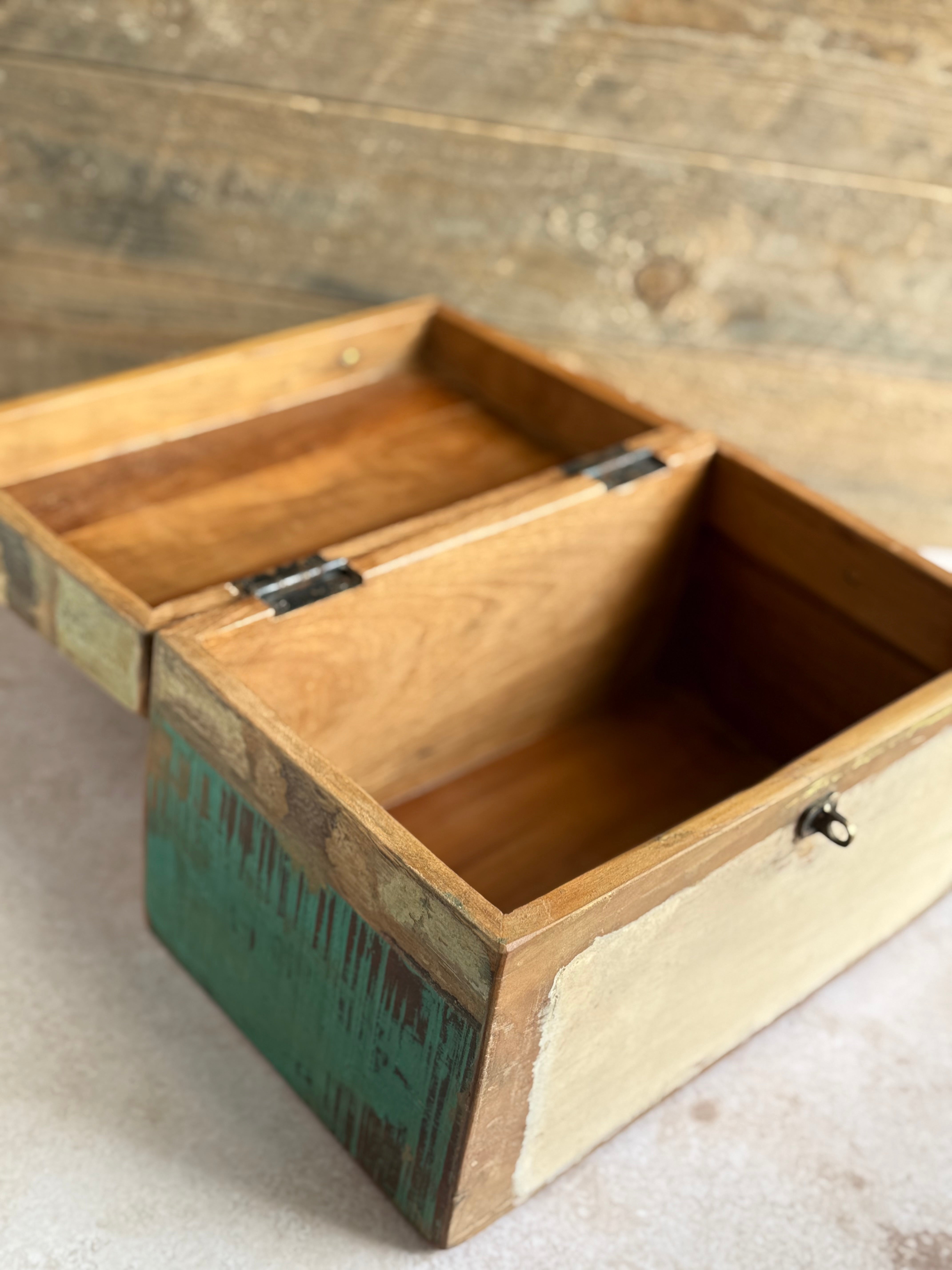 Wooden box with a green base on a wooden surface