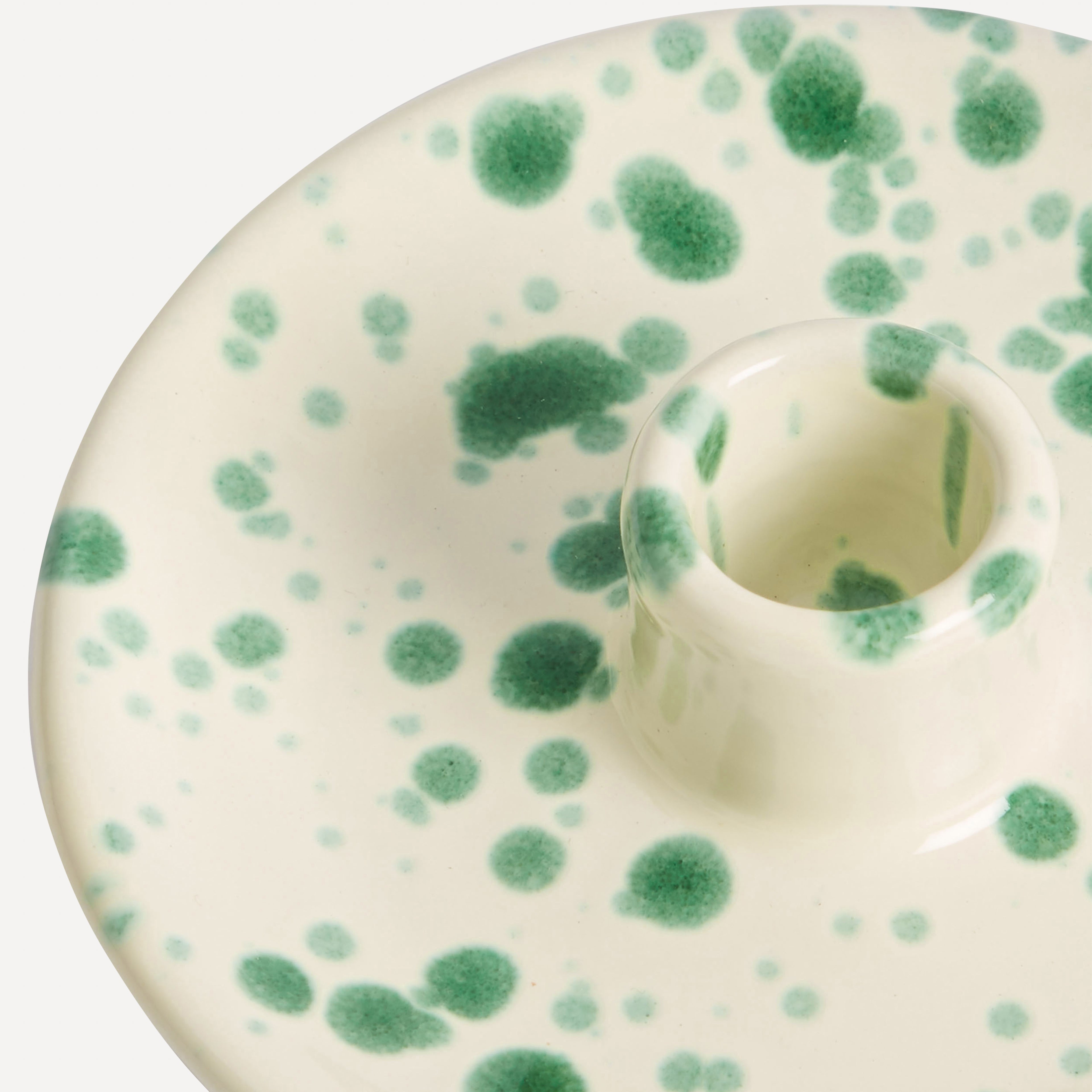 Close up detail shot of green splatter italian ceramic candle holder