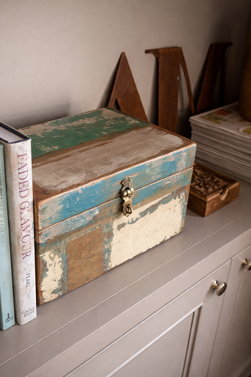 Reclaimed wood box in turquoise tones on bookshelves