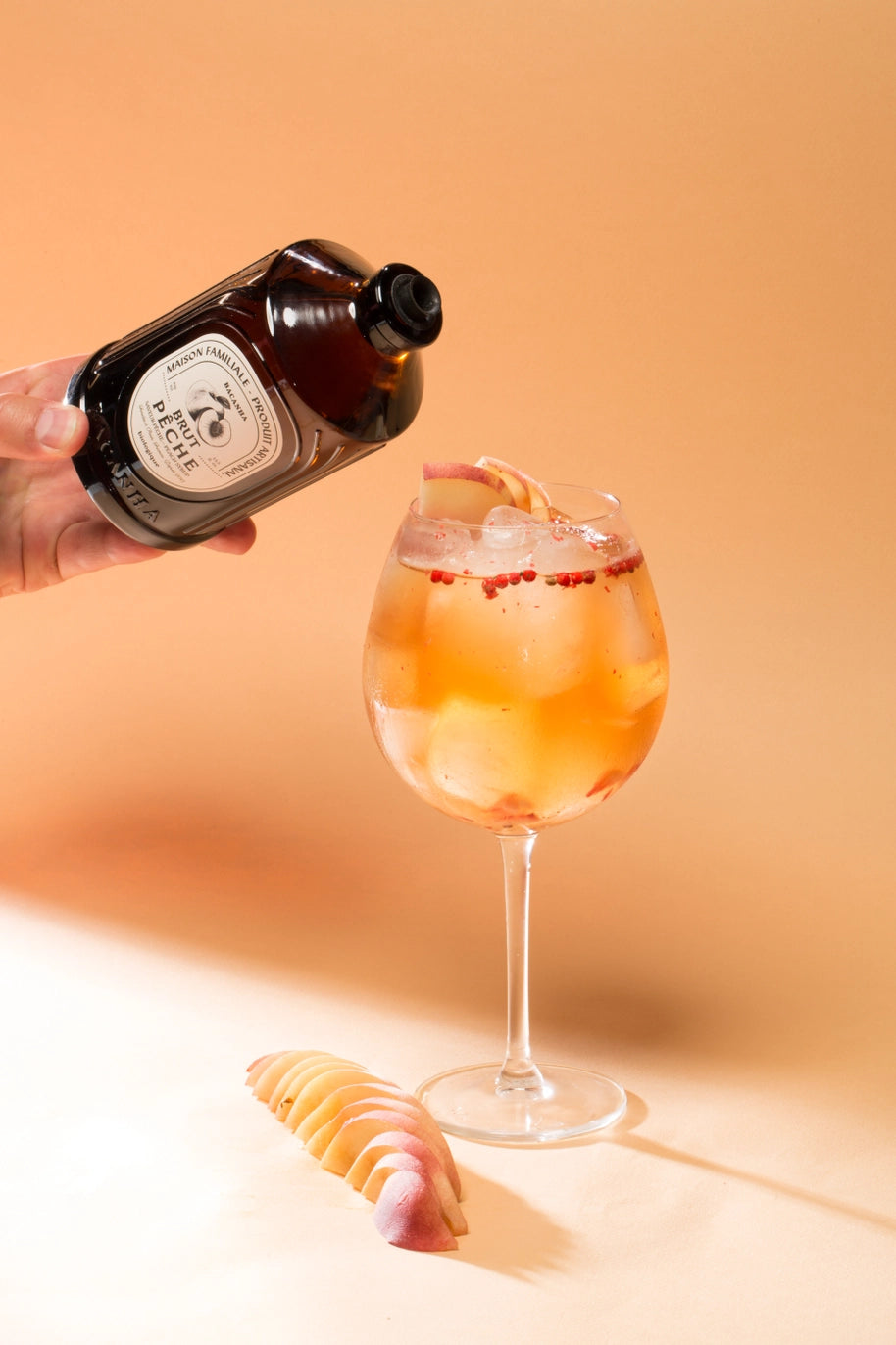 Pouring peach puree to a cocktail