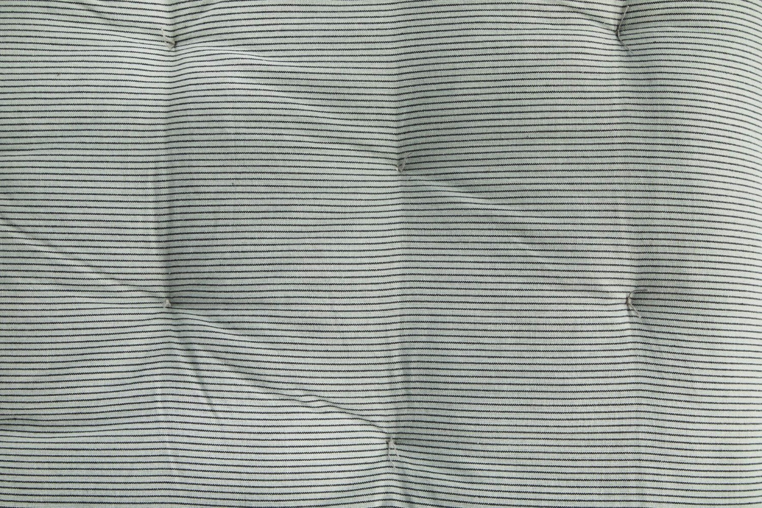 Close up detail of mattress with aqua background with thin black stripes