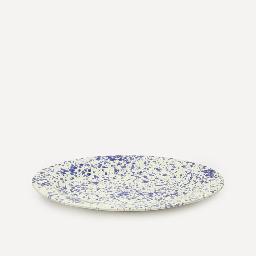Front view of blue splatter ceramic platter against white background
