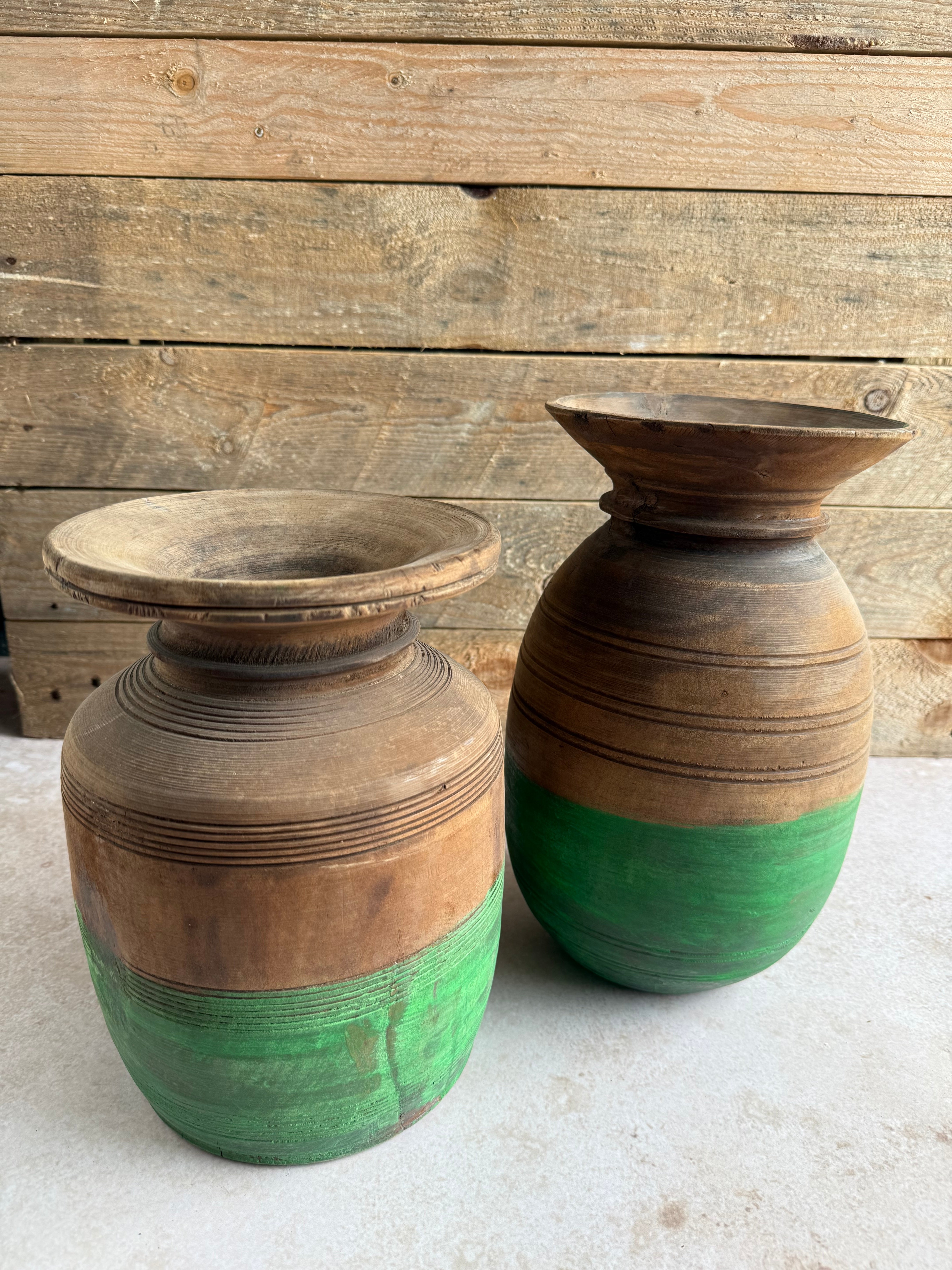 A traditional wooden neck pot with a green painted bottom, sourced in Western Nepal, intended for use as a decorative vase.