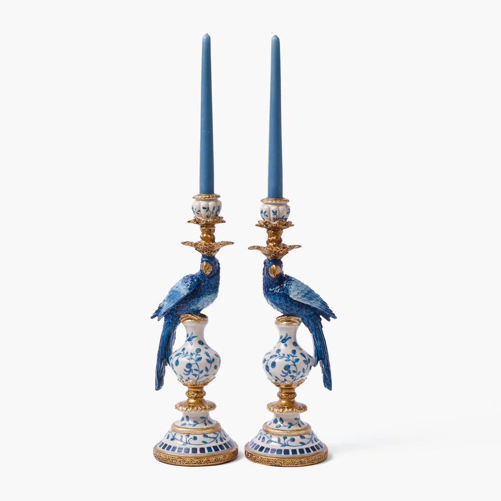 A pair of blue and gold parrot-shaped candleholders with a chinoiserie design.