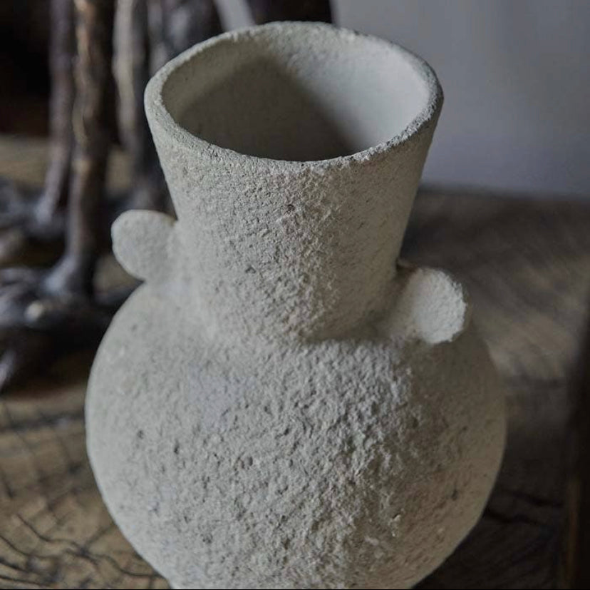 Close up detail shot of creamy textured curvy vase