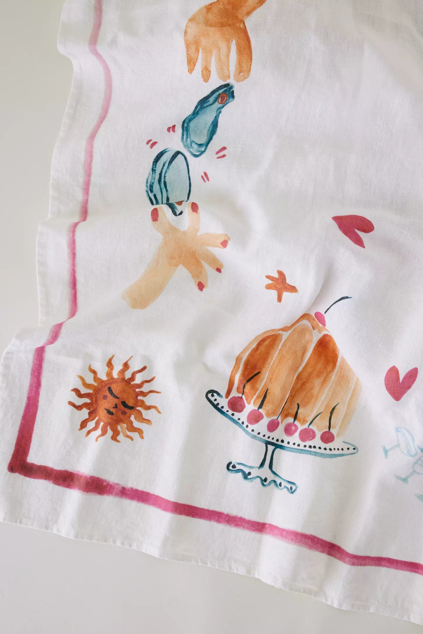 Whimiscal watercolour detail on hand-painted tablecloth at Amber + Willow