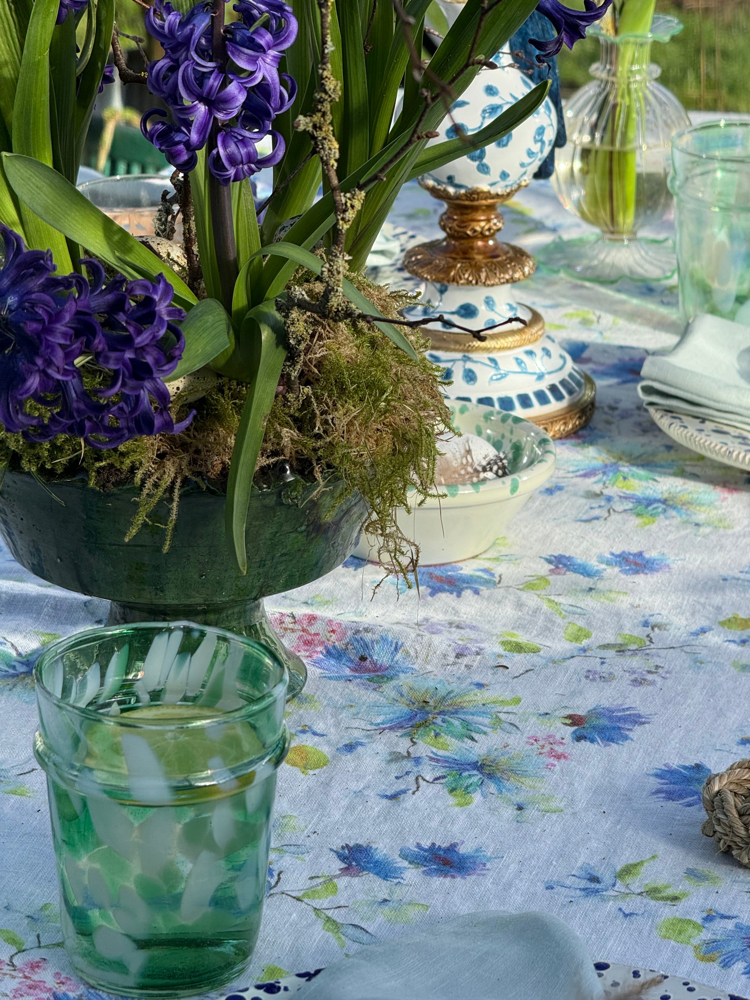 drinking glass with green and white splatter design