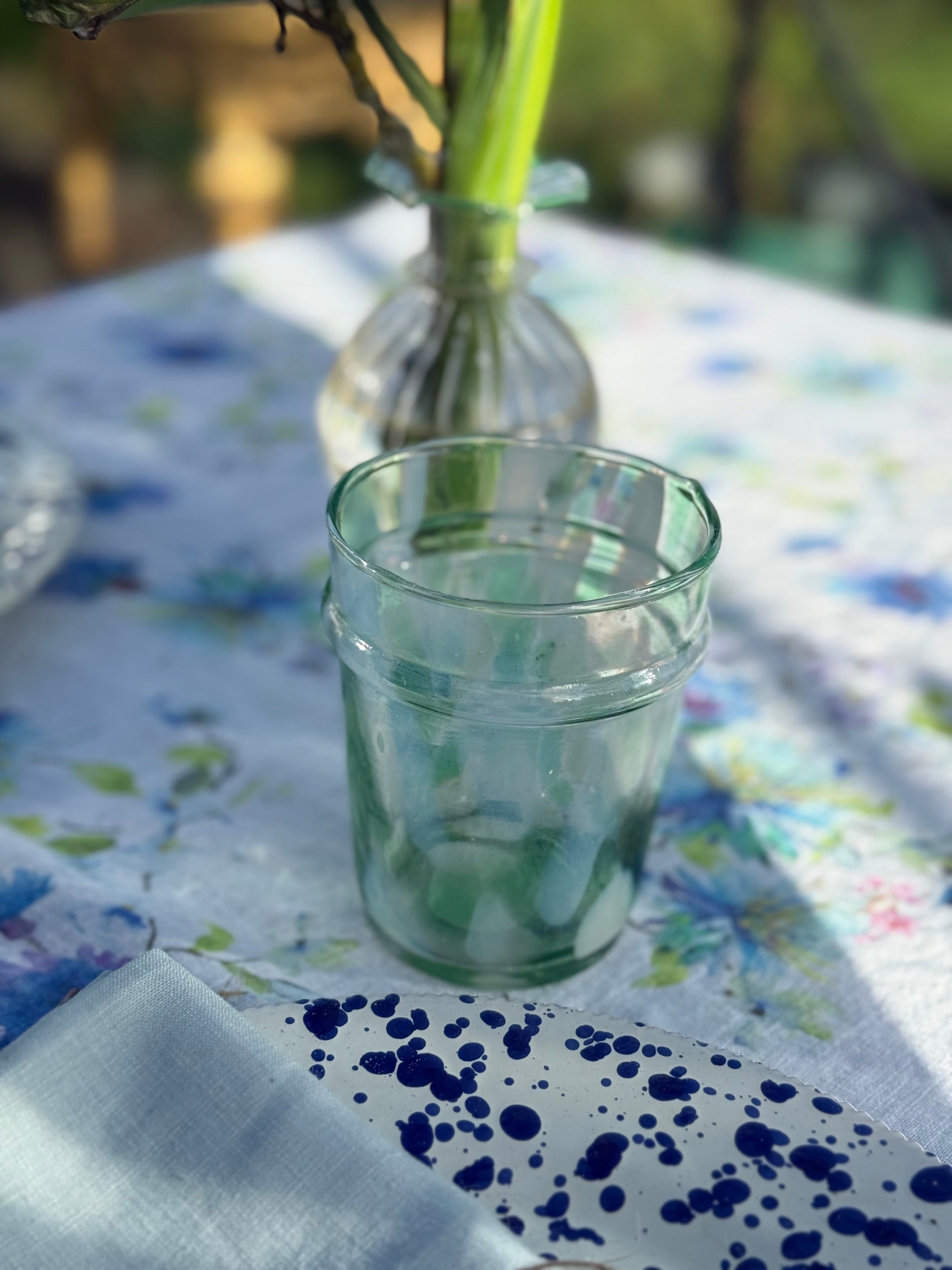 drinking glass with green and white splatter design