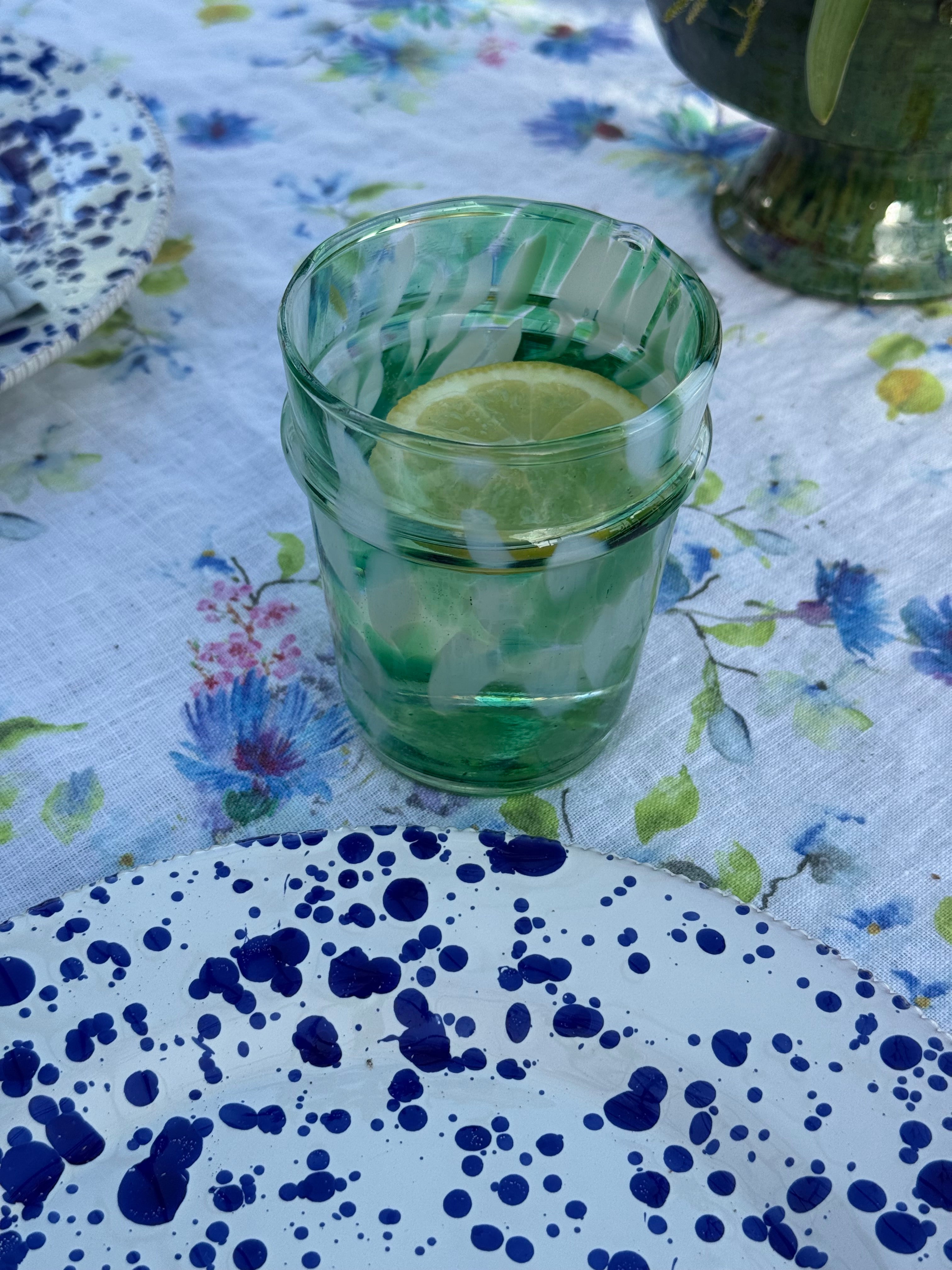 drinking glass with green and white splatter design