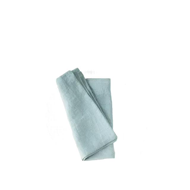 Cut out of duck egg blue linen napkin folded on white background