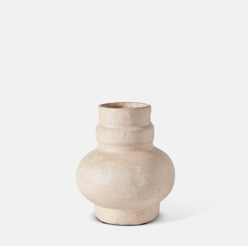 Creamy beige textured vase on white background