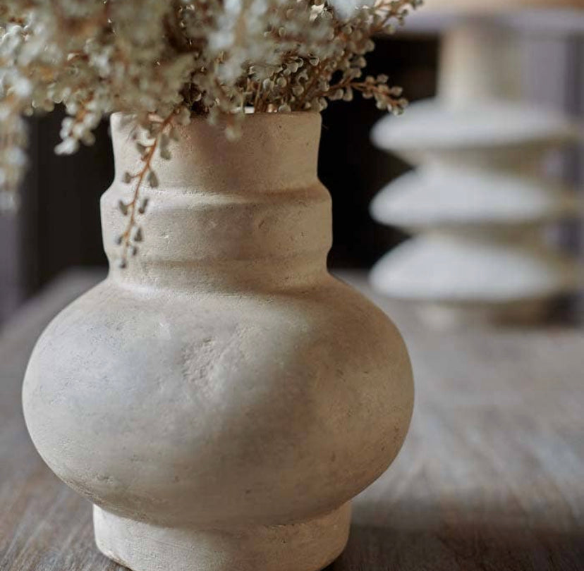 Close up shot of creamy beige textured vase