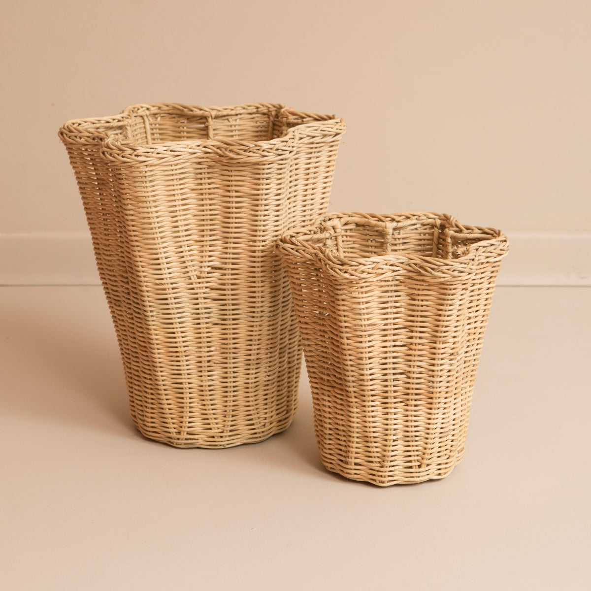 Two rattan wavy vases on beige background