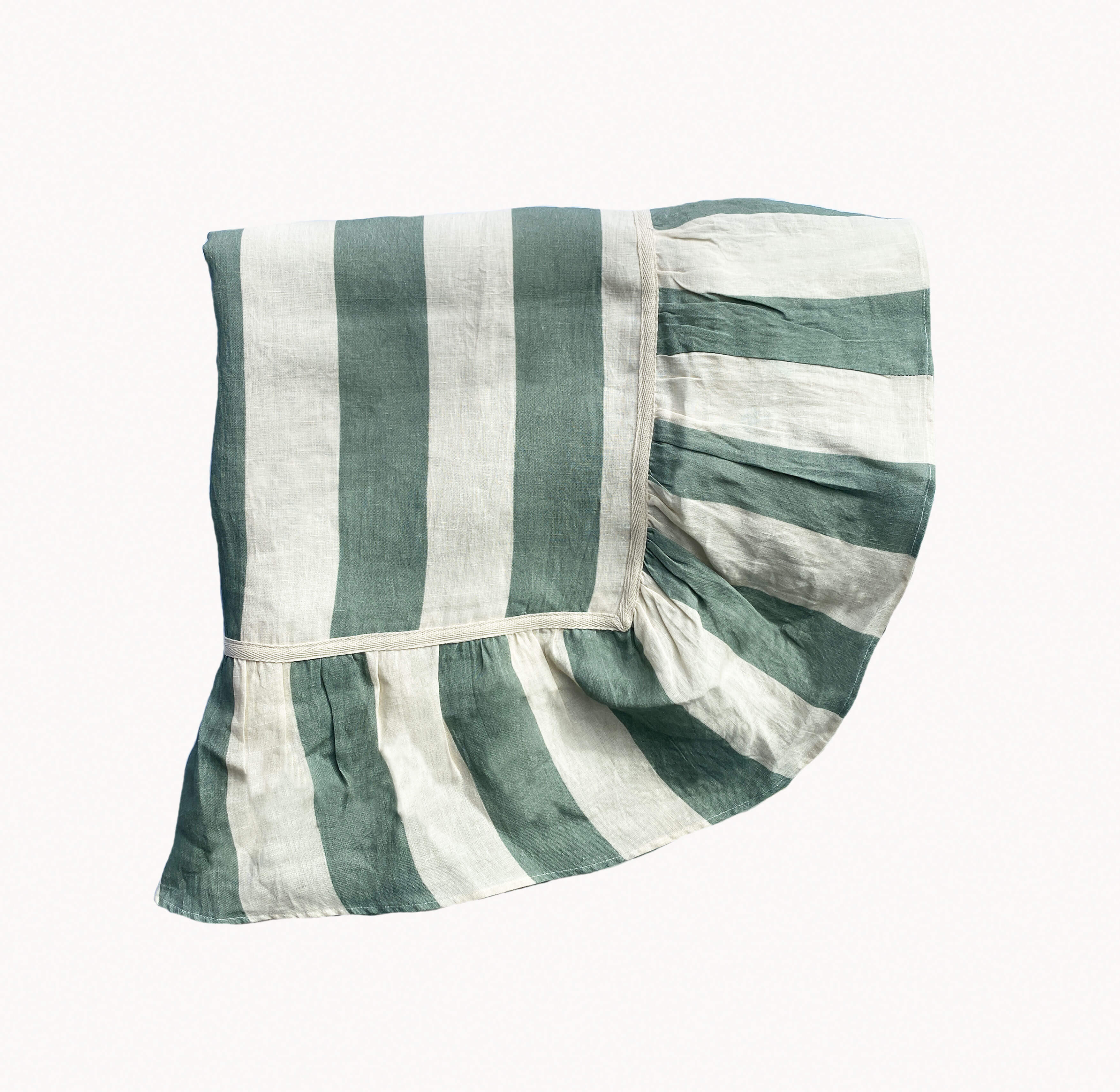 A sea green and white striped linen ruffle tablecloth on a white background