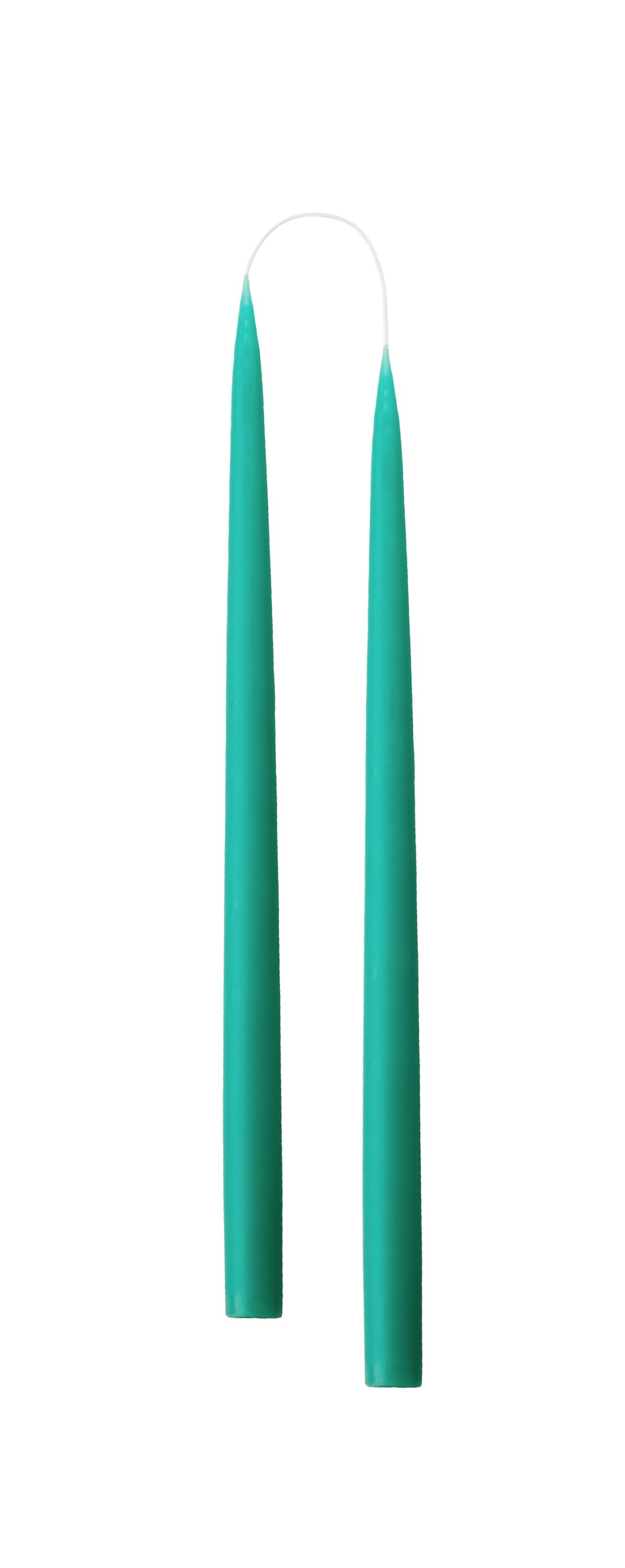 Two turquoise candles on a white background