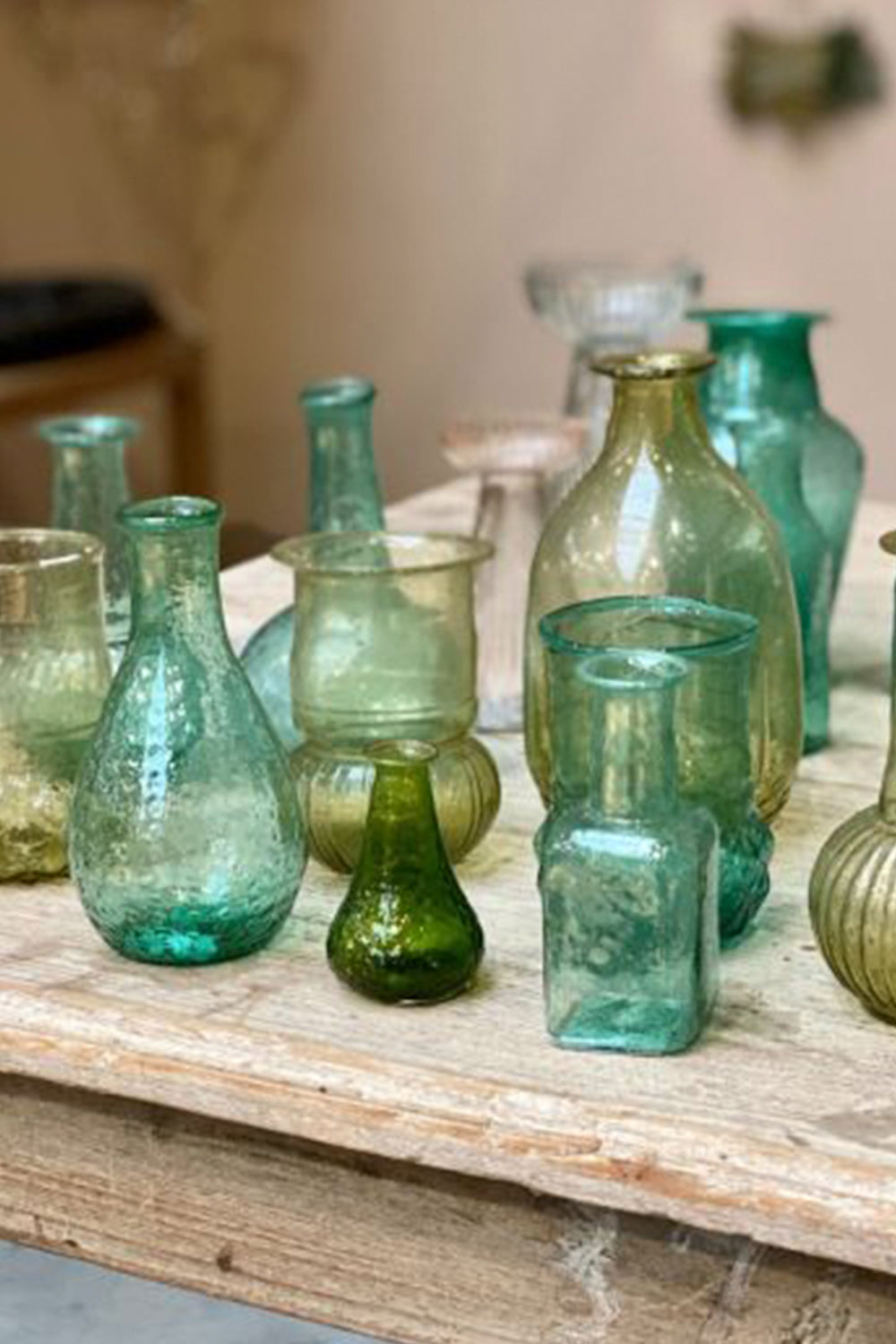 Vintage seagreen bottles on rustic table