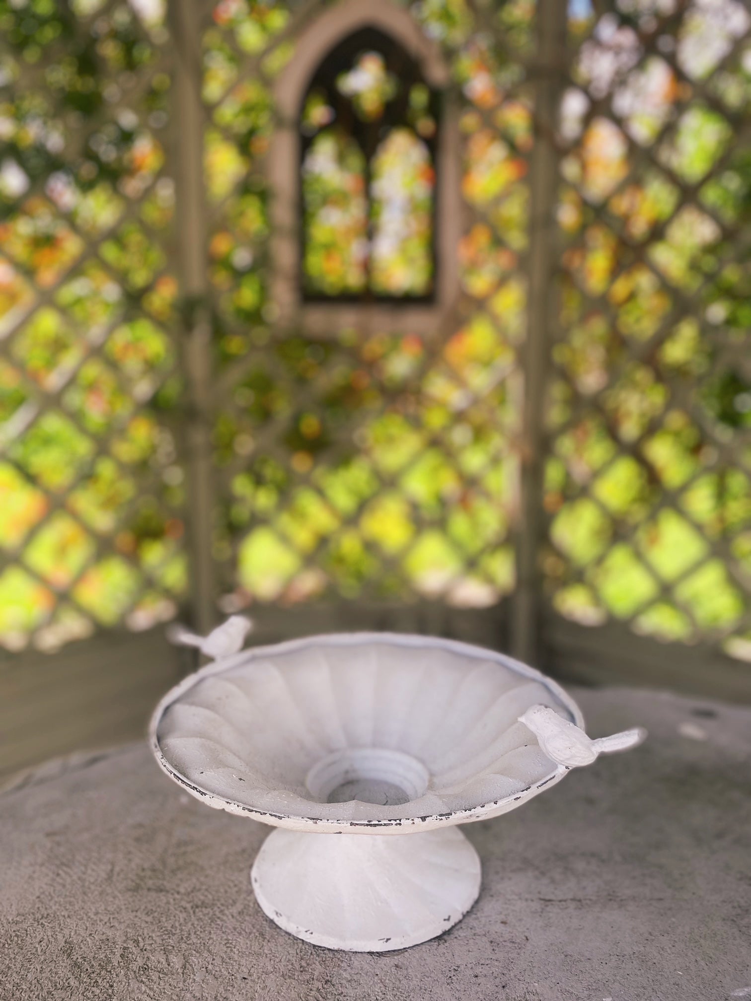 Distressed white metal bird bath at Amber + WIllow