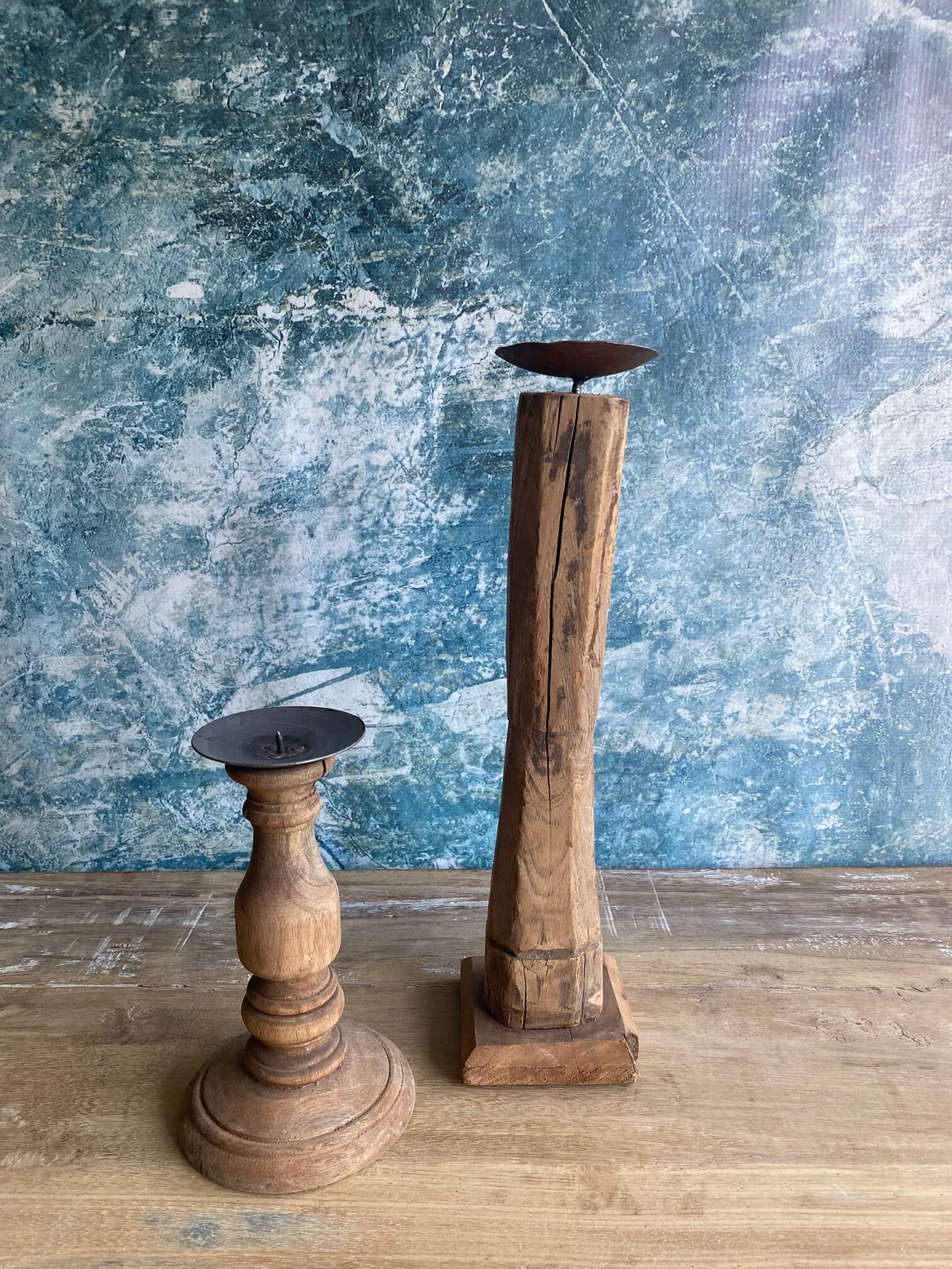 reclaimed wood candle sticks against blue textured background