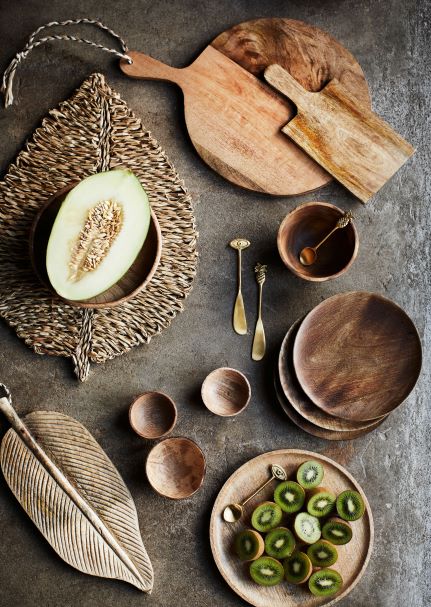 Aerial view of wooden bowls and plates on a slate surface