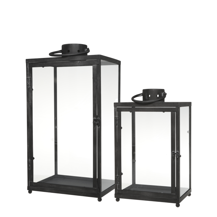 Two black metal lanterns with glass panels on a white background