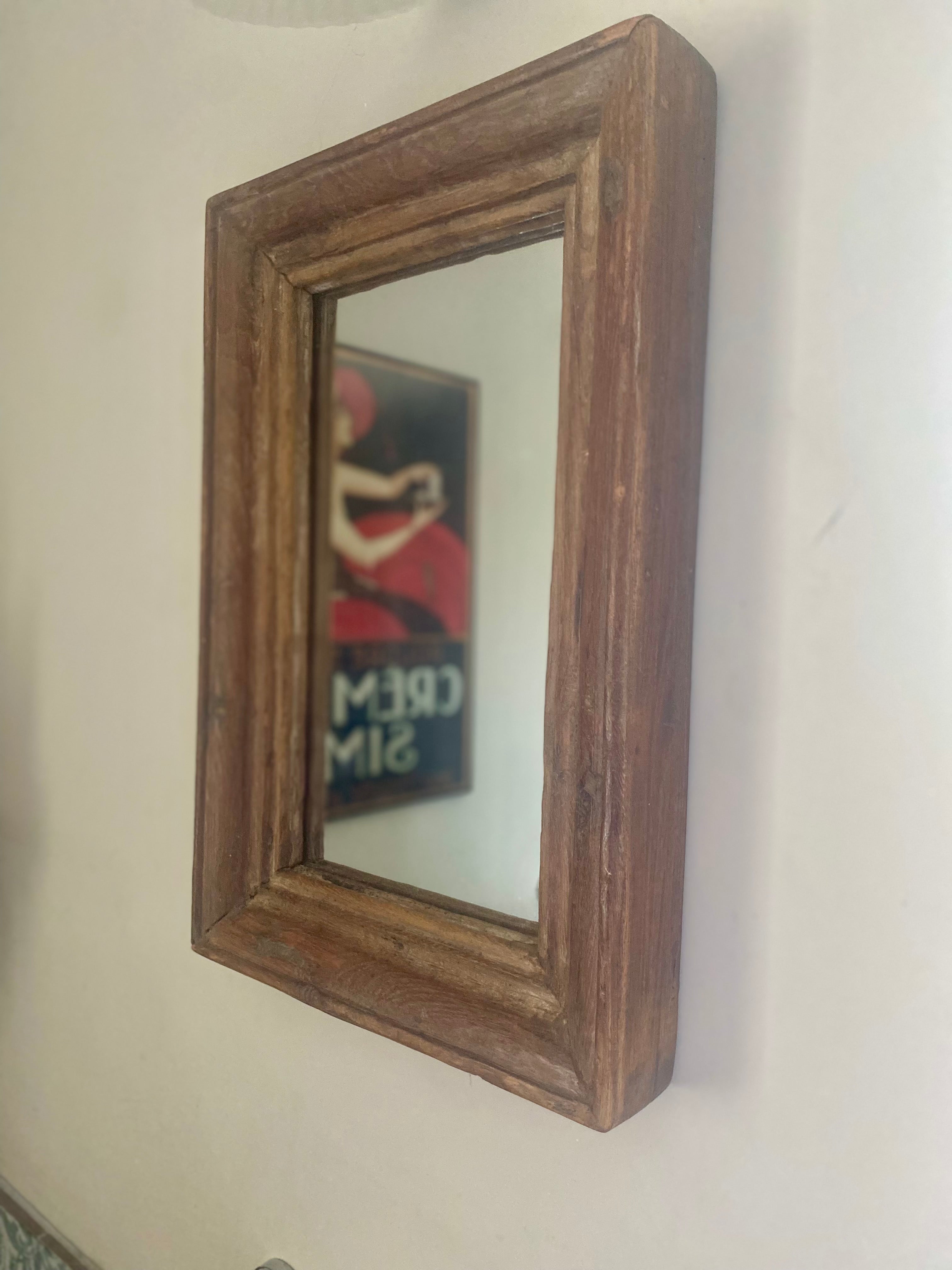 Reclaimed wood framed mirror on a white wall
