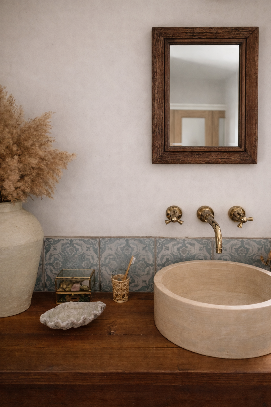 Bathroom with wooden vanity, stone sink, and reclaimed wood mirror 