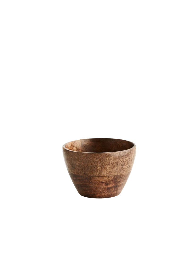 This image features a handmade mango wood bowl, crafted with a unique hand-scorched finish that imparts a distinct texture and color. The bowl's natural wood patterns and rich hue highlight its organic origin and artisanal heritage.