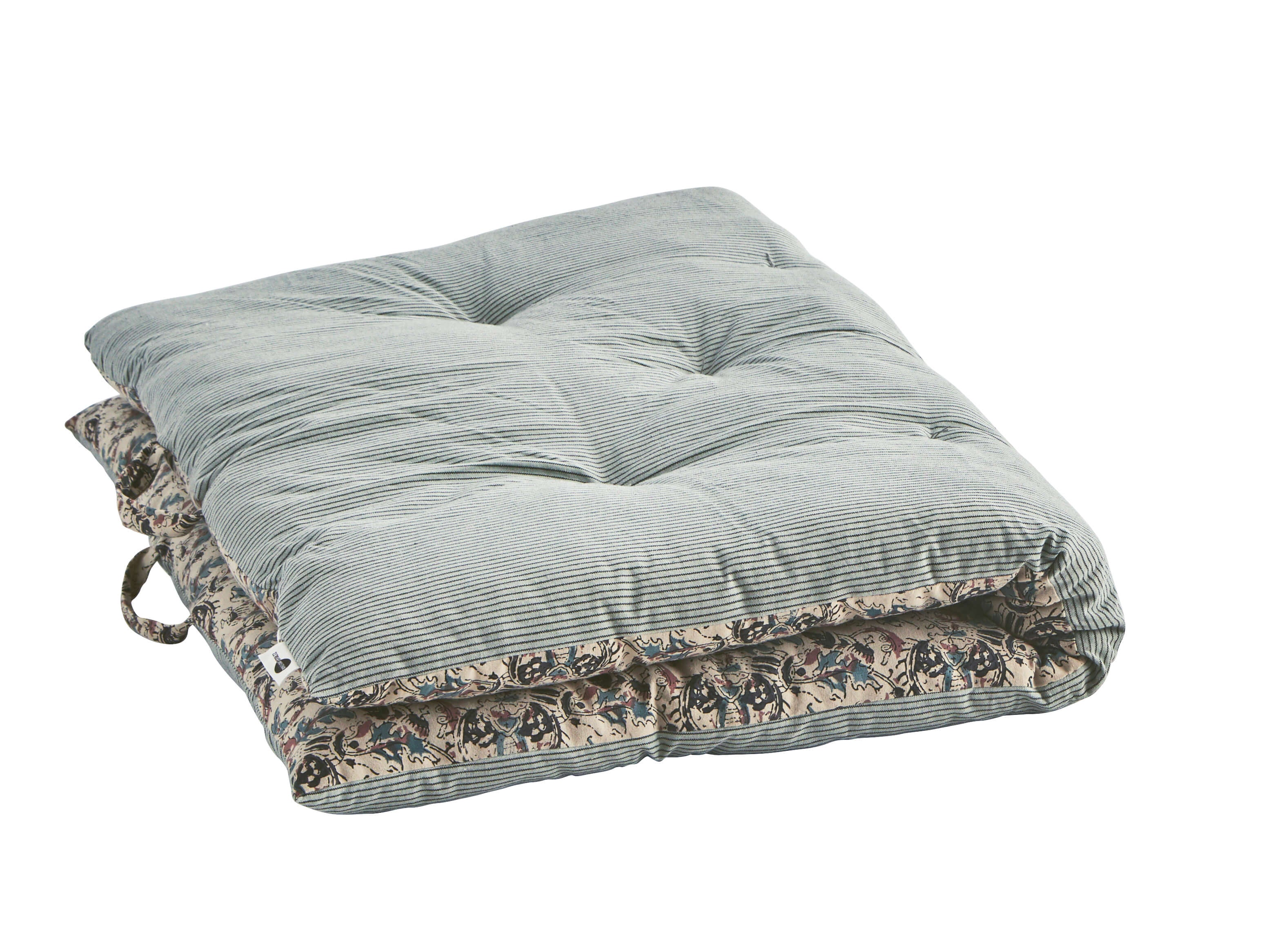 Folded block print mattress with handles on white background