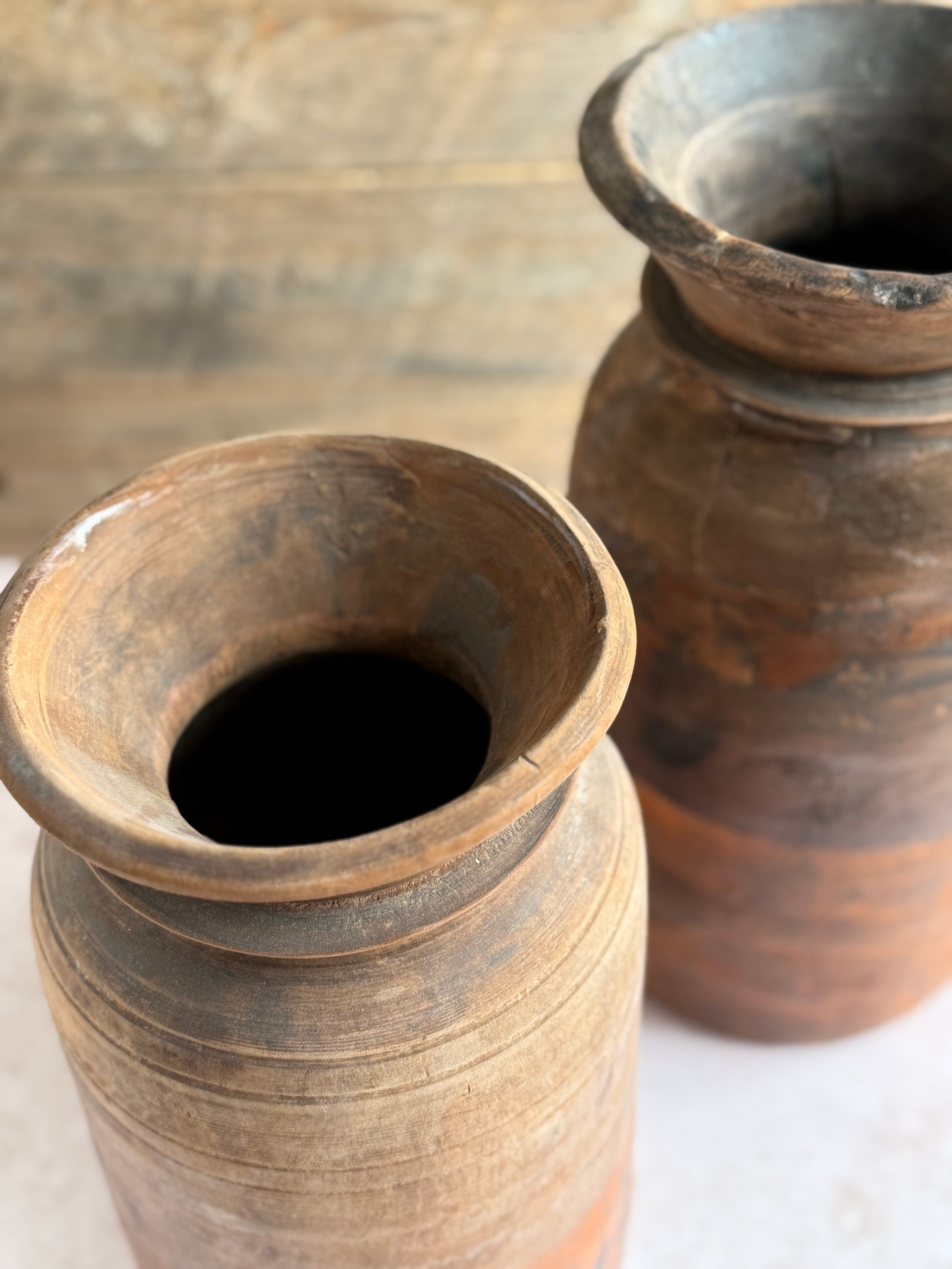 Two wooden vases on a table