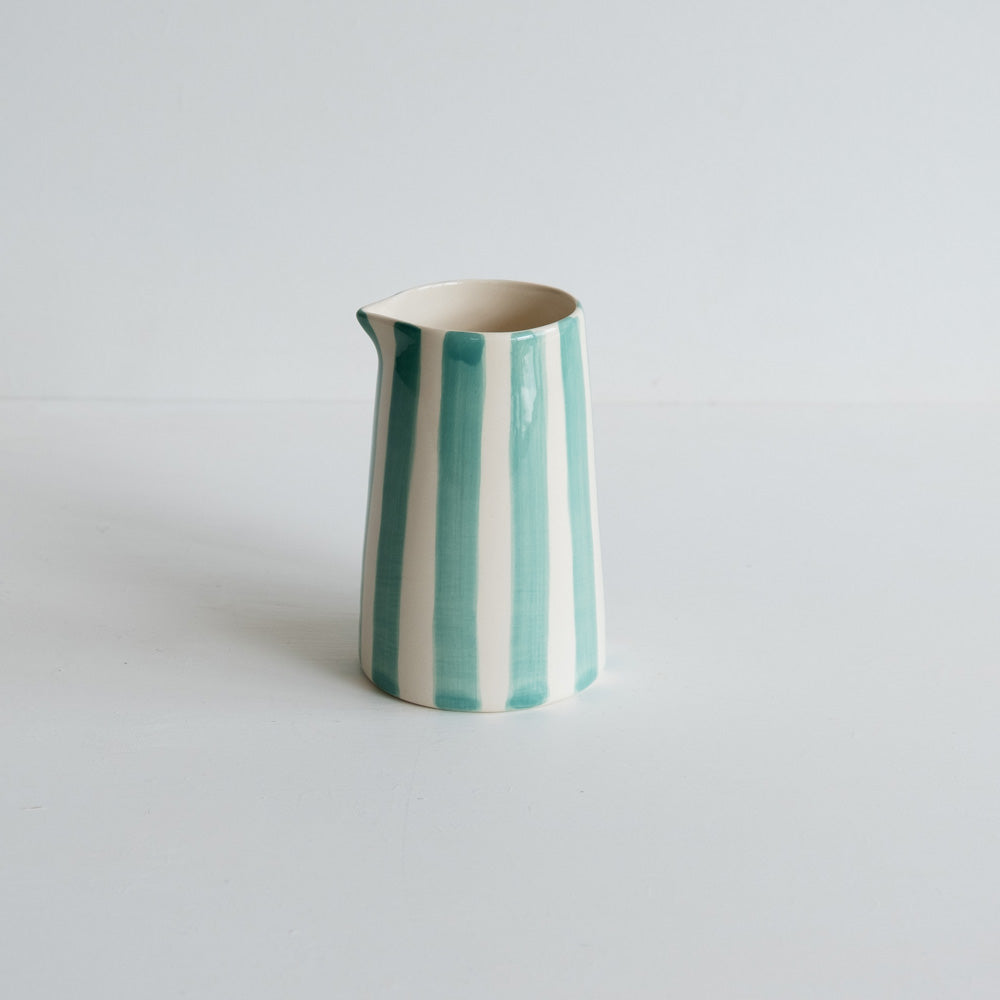 Mint striped handmade ceramic jug on white background