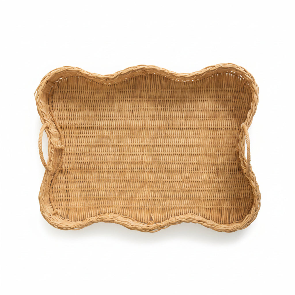 Overhead view of woven scalloped rattan tray on a white background