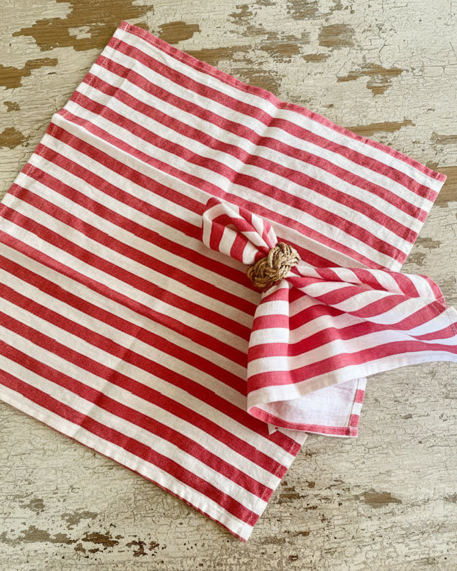 Red and white striped linen napkins on a textured surface