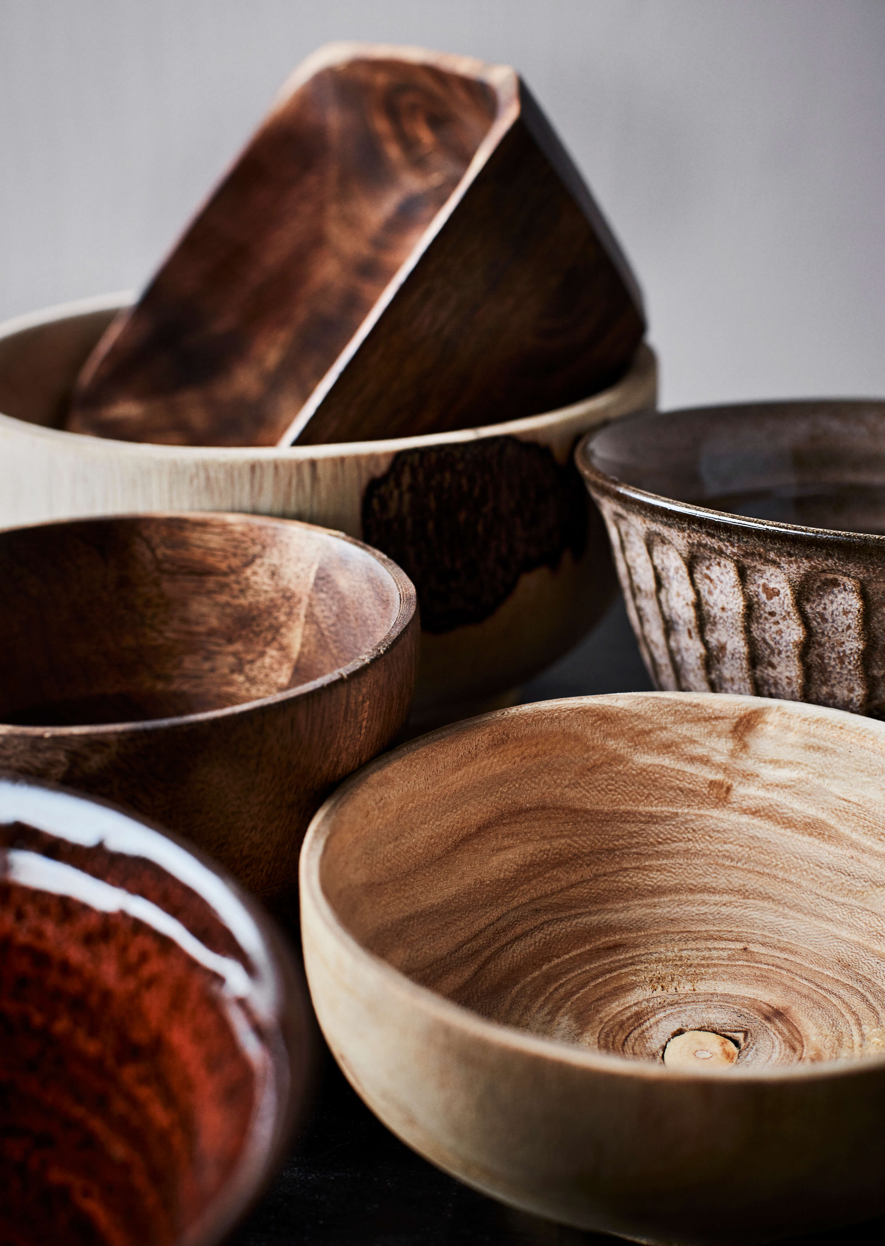 Detail of selection of wood bowls with different textures and colours
