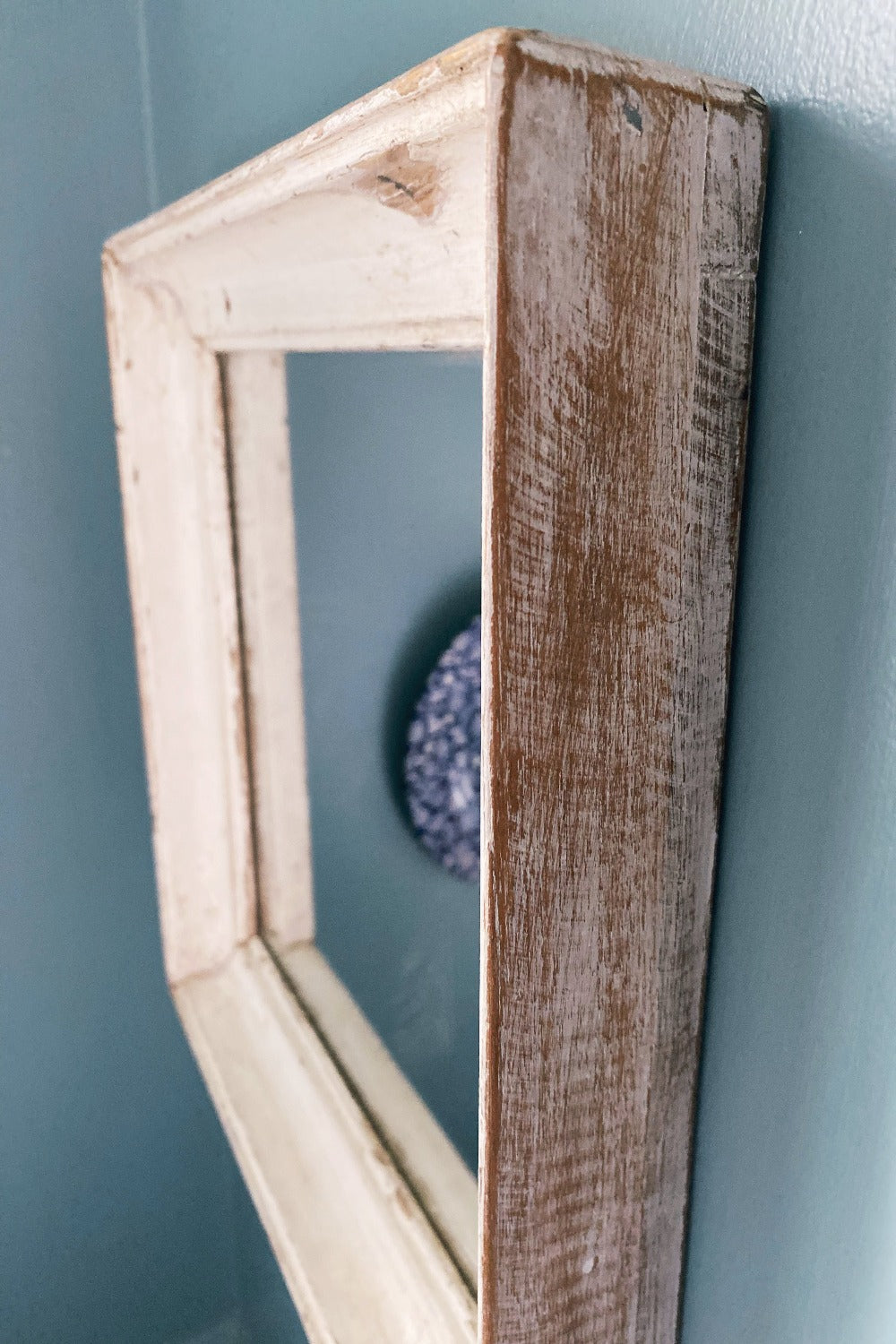 Close up of reclaimed wood white mirror frame